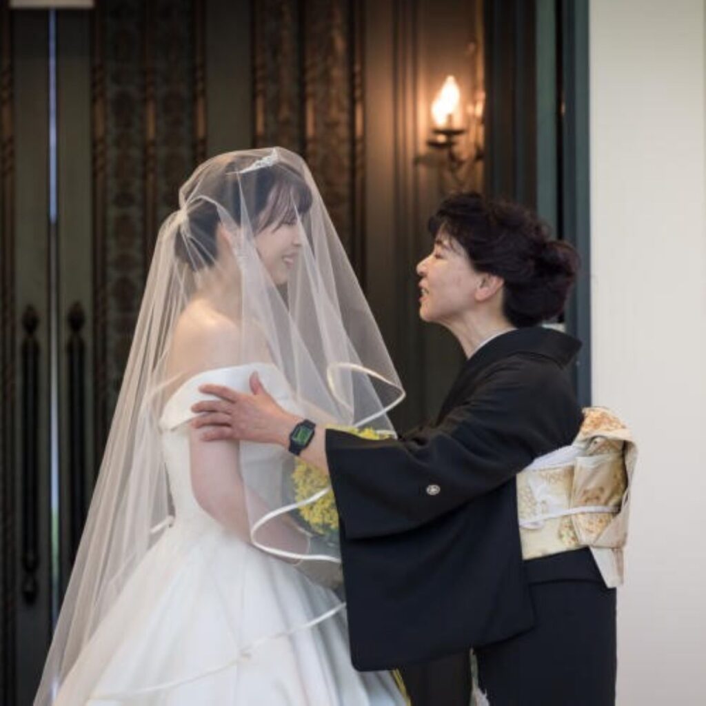 お母様からのベールダウンとお父様との入場。家族の愛に包まれ、絆を深める感動のひととき。