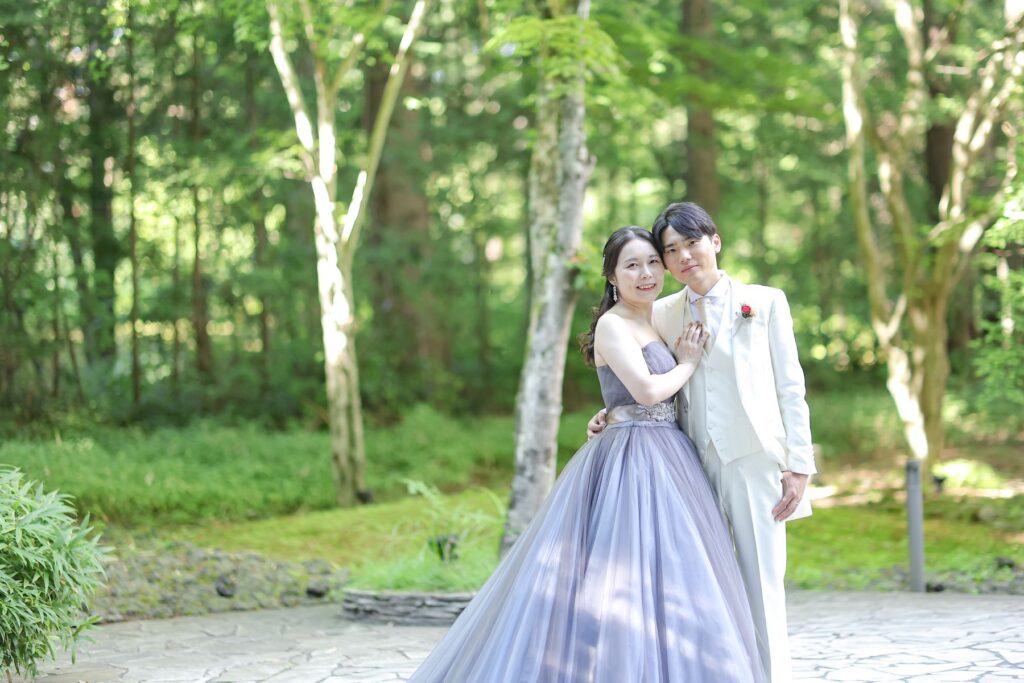 軽井沢の自然光の中で輝く、パープルドレス。緑に映えるカラードレスでのロケーションフォトは、アネーリ軽井沢で叶えるリゾートウエディングの特別な思い出です。