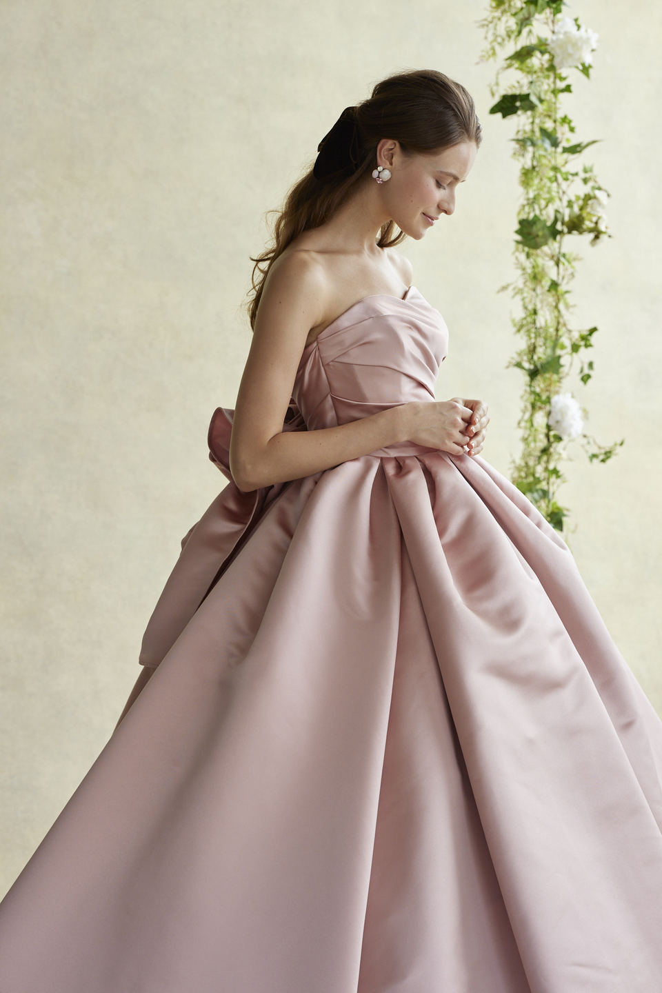 アネーリ軽井沢提携衣装店のダスティピンクのカラードレス。ハリのあるサテン生地と大きなバックリボンが大人の可愛らしさを演出。軽井沢のクラシカルな会場に映えるお色直しスタイル。
