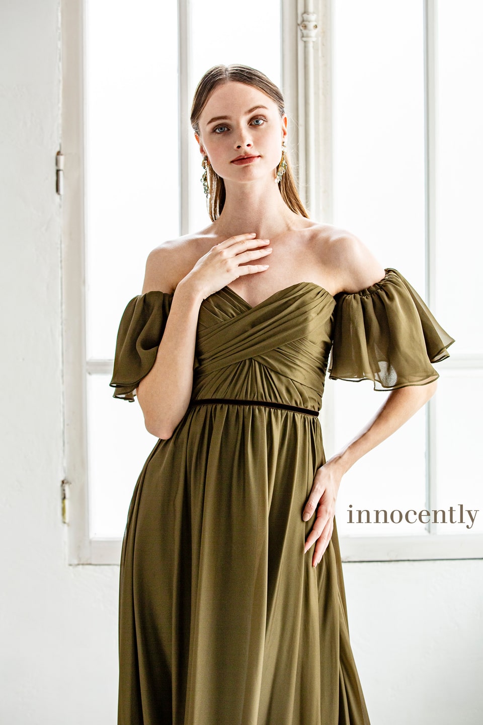 アネーリ軽井沢提携イノセントリーのオリーブグリーンのカラードレス。オフショルダーのパフスリーブと胸元のドレープが特徴的な、リゾートウェディングやナチュラルなガーデン挙式に合うお色直しドレス。落ち着いた大人の花嫁に。